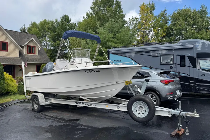 The Image of 2019 Edgewater 188CC boat on trailer, parked near house and RV. - 0