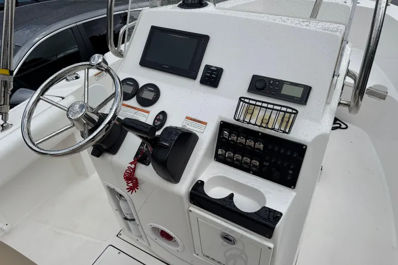 Slide: The Image of Control panel of a 2019 Edgewater 188CC boat with steering wheel and instruments. - 11