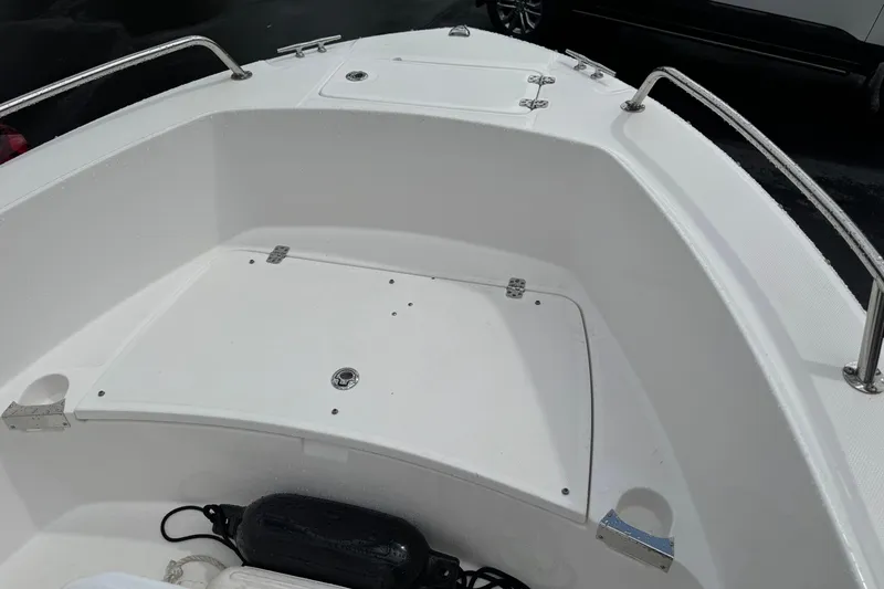 Slide: The Image of 2019 Edgewater 188CC boat interior with storage compartments and stainless steel railings. - 13