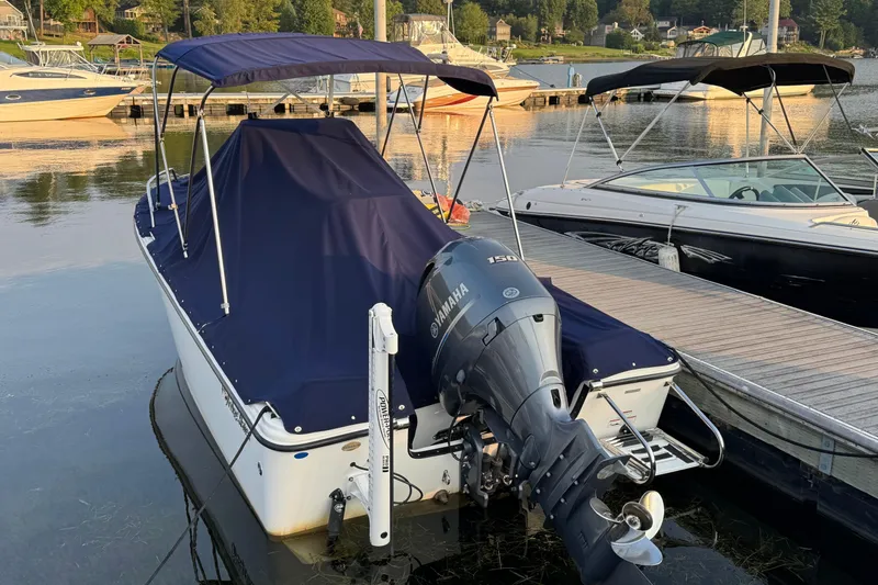 Slide: The Image of 2019 Edgewater 188CC boat with Yamaha motor docked at a marina. - 17