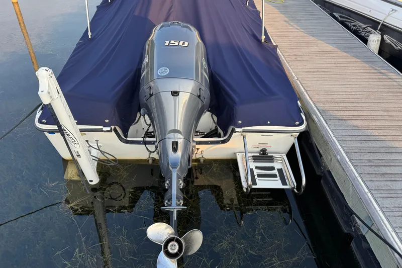 Slide: The Image of 2019 Edgewater 188CC boat with Yamaha 150 engine, docked and covered. - 18