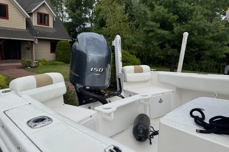 Slide: The Image of 2019 Edgewater 188CC boat with Yamaha 150 engine, parked near a house. - 3
