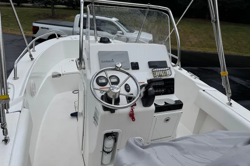 Slide: The Image of 2019 Edgewater 188CC boat cockpit with steering wheel and Garmin navigation system. - 7