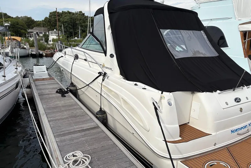 The Image of 2001 Sea Ray 340 Sundancer docked, featuring sleek design and black canopy. - 0