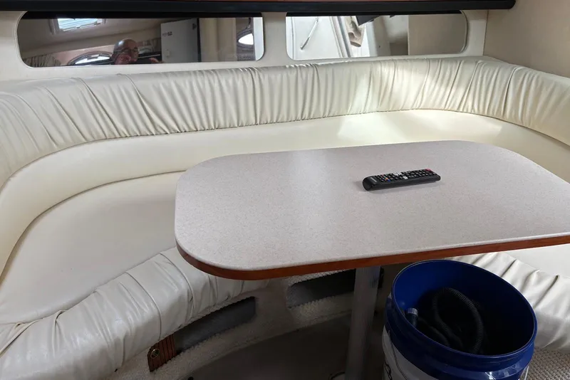 Slide: The Image of Interior of 2001 Sea Ray 340 Sundancer with cream seating and table. - 10