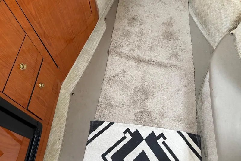 Slide: The Image of Interior of 2001 Sea Ray 340 Sundancer with carpet and wooden cabinetry. - 14