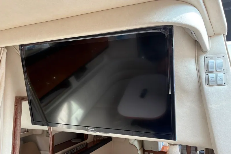 Slide: The Image of Flat-screen TV inside 2001 Sea Ray 340 Sundancer yacht cabin, with control panel nearby. - 16
