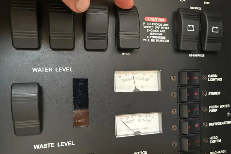 Slide: The Image of Control panel of a 2001 Sea Ray 340 Sundancer boat, showing water level and electrical gauges. - 18