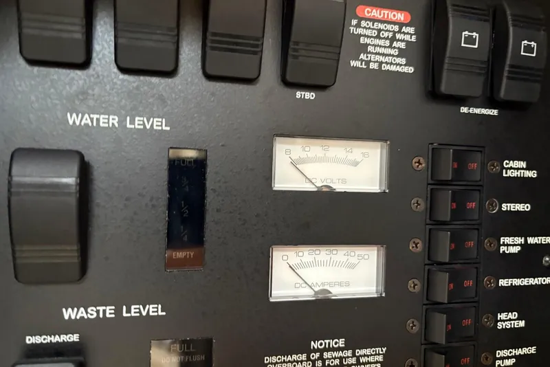 Slide: The Image of Control panel of a 2001 Sea Ray 340 Sundancer boat, showing water levels and electrical gauges. - 19