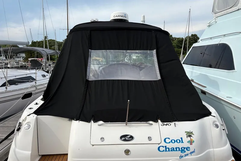 Slide: The Image of 2001 Sea Ray 340 Sundancer docked, featuring black canvas cover and "Cool Change" text. - 2