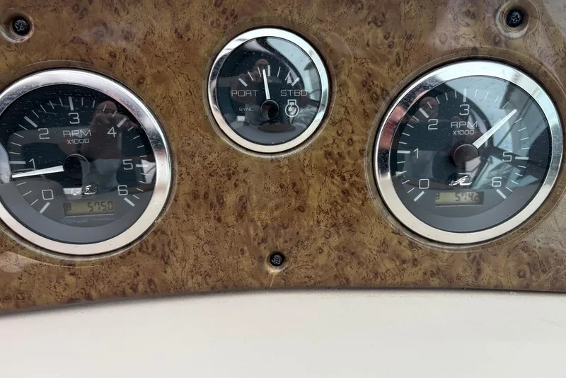 Slide: The Image of Dashboard of 2001 Sea Ray 340 Sundancer with RPM gauges and wood finish. - 20