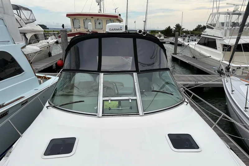 Slide: The Image of 2001 Sea Ray 340 Sundancer docked at marina, featuring sleek design and Garmin equipment. - 26