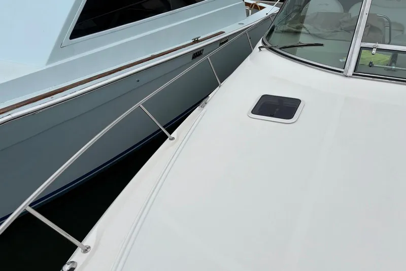 Slide: The Image of 2001 Sea Ray 340 Sundancer yacht docked beside another boat. - 27