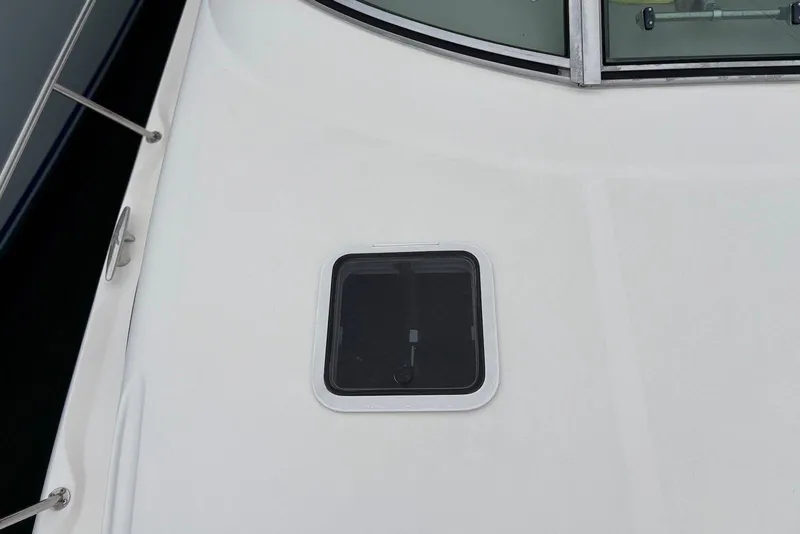 Slide: The Image of Close-up of 2001 Sea Ray 340 Sundancer deck with a small hatch window. - 30