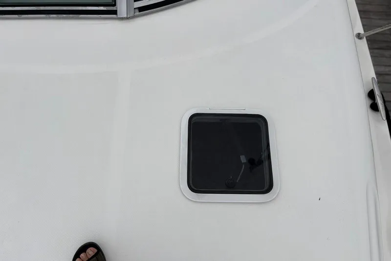 Slide: The Image of 2001 Sea Ray 340 Sundancer deck with hatch and partial foot view. - 31