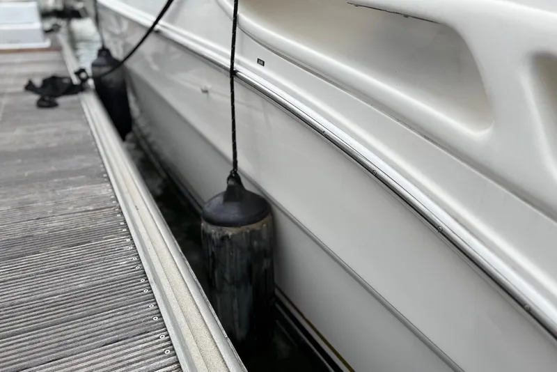 Slide: The Image of 2001 Sea Ray 340 Sundancer docked with fenders, side view. - 33