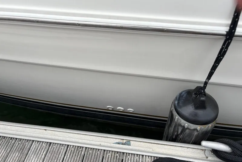 Slide: The Image of 2001 Sea Ray 340 Sundancer docked with fender and rope. - 34