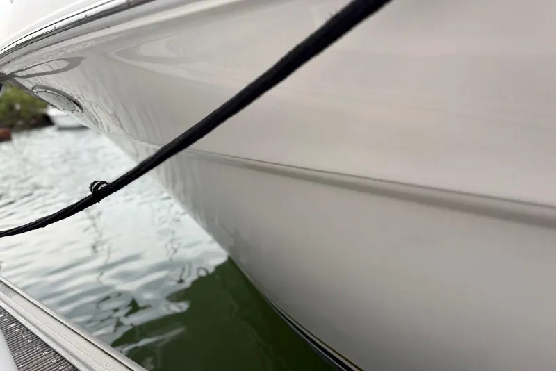 Slide: The Image of Side view of a 2001 Sea Ray 340 Sundancer boat docked by the water. - 35