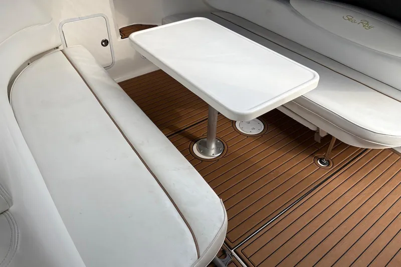 Slide: The Image of Interior of 2001 Sea Ray 340 Sundancer with white seating and wooden flooring. - 4