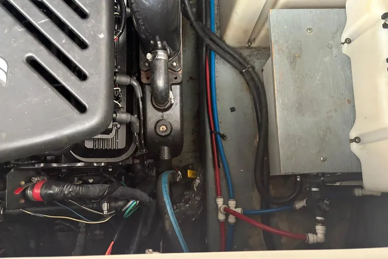 Slide: The Image of Engine compartment of a 2001 Sea Ray 340 Sundancer boat, showing mechanical components and wiring. - 40