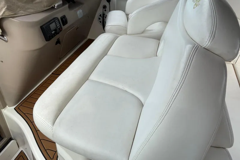 Slide: The Image of White leather seating on a 2001 Sea Ray 340 Sundancer boat interior. - 5
