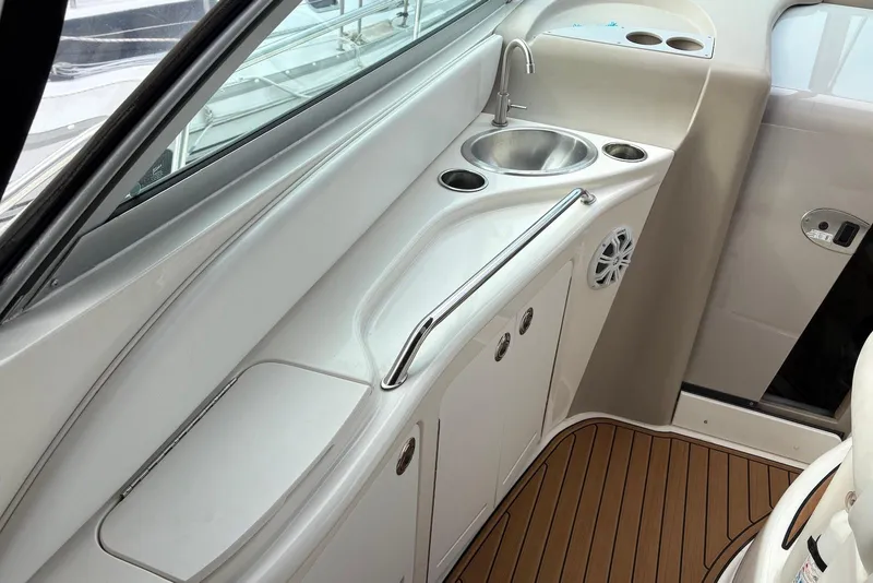 Slide: The Image of 2001 Sea Ray 340 Sundancer boat interior with sink and storage area. - 6