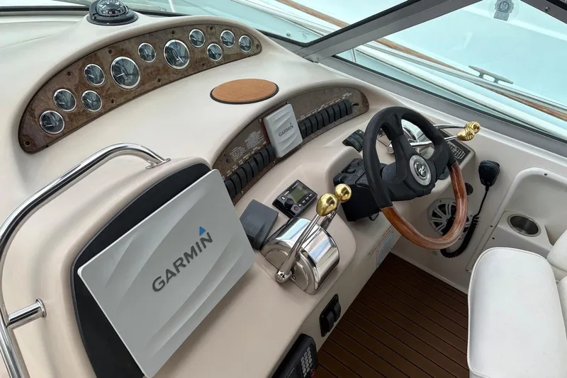 Slide: The Image of Cockpit of 2001 Sea Ray 340 Sundancer with Garmin navigation system and wooden steering wheel. - 7