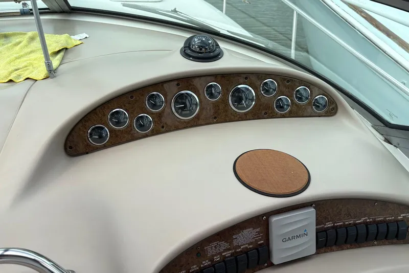 Slide: The Image of Dashboard of a 2001 Sea Ray 340 Sundancer boat with gauges and Garmin device. - 8
