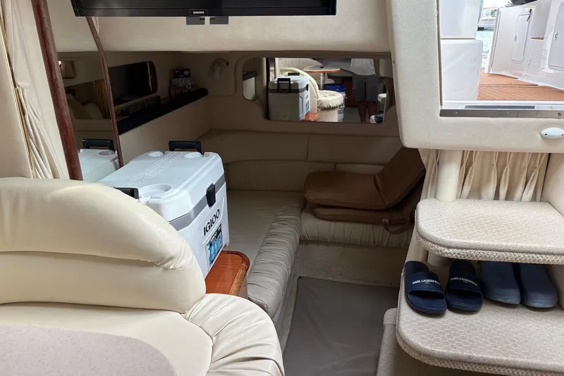 Slide: The Image of Interior of 2001 Sea Ray 340 Sundancer yacht with seating, cooler, and slippers. - 9