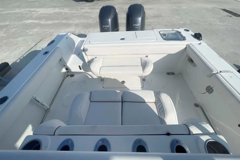 Slide: The Image of 2019 Sea Hunt Gamefish 27 boat interior with seating and dual 150 engines. - 2