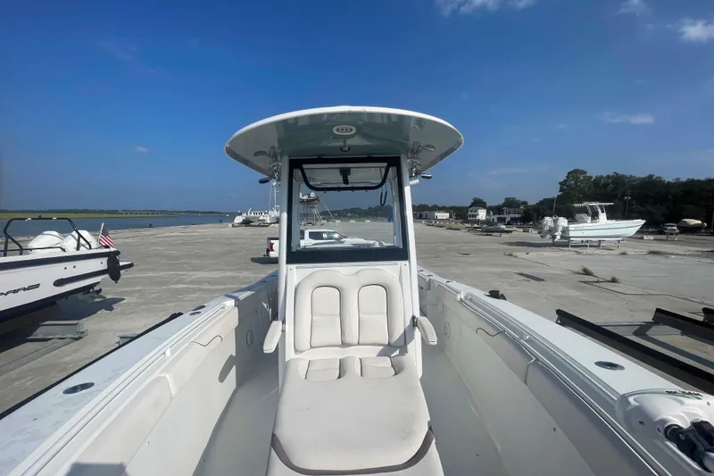 Slide: The Image of 2019 Sea Hunt Gamefish 27 boat docked at marina under clear blue sky. - 5