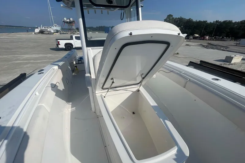 Slide: The Image of 2019 Sea Hunt Gamefish 27 boat with open storage compartment on deck. - 6