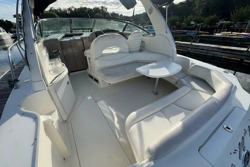 Slide: The Image of 2001 Sea Ray 380 Sundancer boat interior with white seating and table. - 11