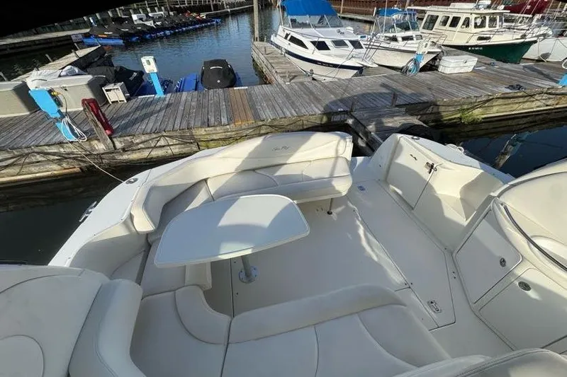 Slide: The Image of 2001 Sea Ray 380 Sundancer boat interior with seating and table at marina. - 13