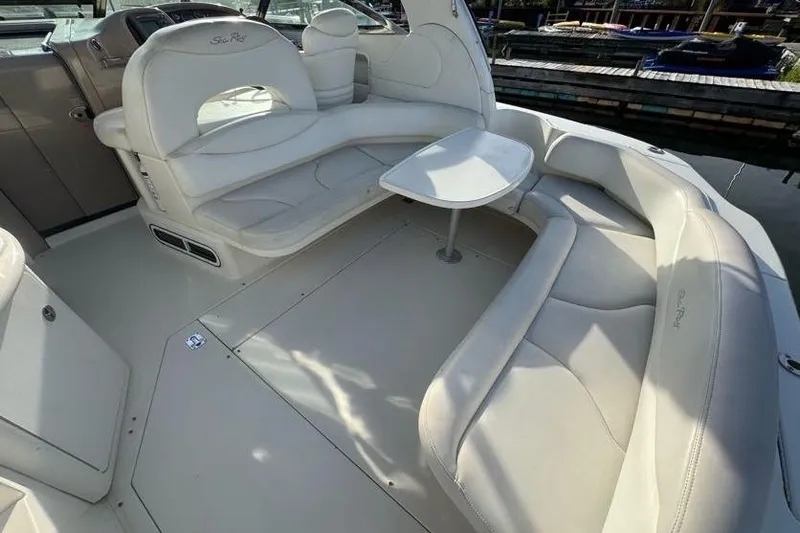 Slide: The Image of 2001 Sea Ray 380 Sundancer interior with white leather seating and table. - 14