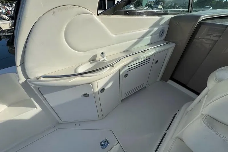 Slide: The Image of Interior of 2001 Sea Ray 380 Sundancer yacht, featuring a sleek white kitchenette. - 15