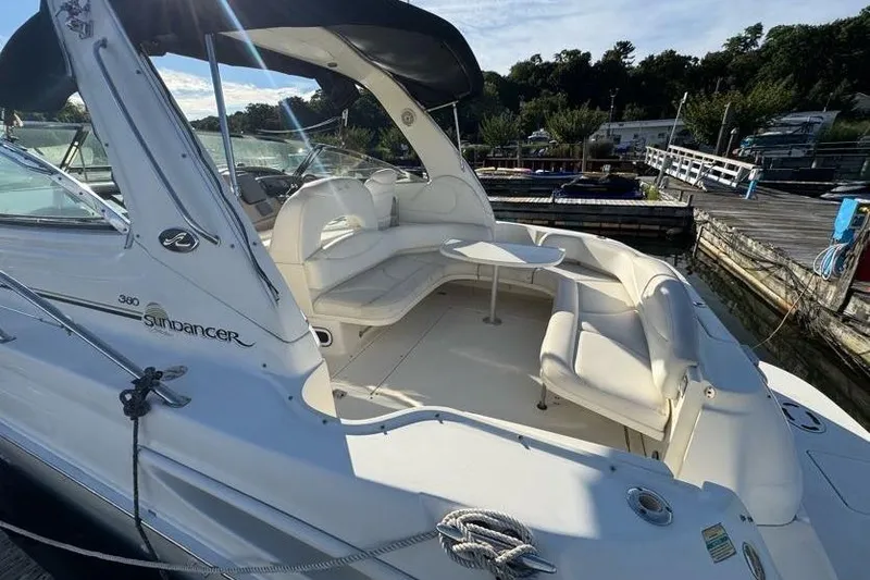Slide: The Image of 2001 Sea Ray 380 Sundancer yacht with spacious seating at a marina. - 21