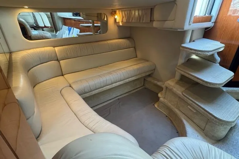 Slide: The Image of Luxurious interior of 2001 Sea Ray 380 Sundancer with beige leather seating. - 25