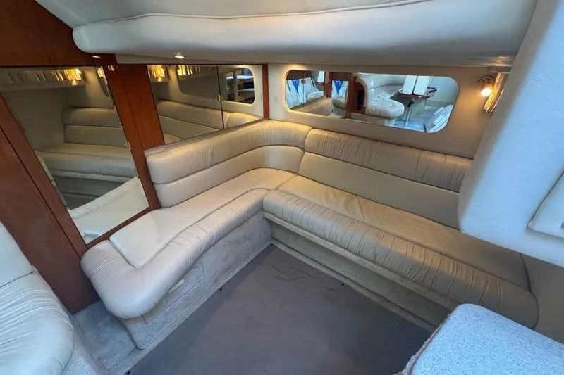 Slide: The Image of Luxurious interior of 2001 Sea Ray 380 Sundancer with beige leather seating and mirrors. - 26