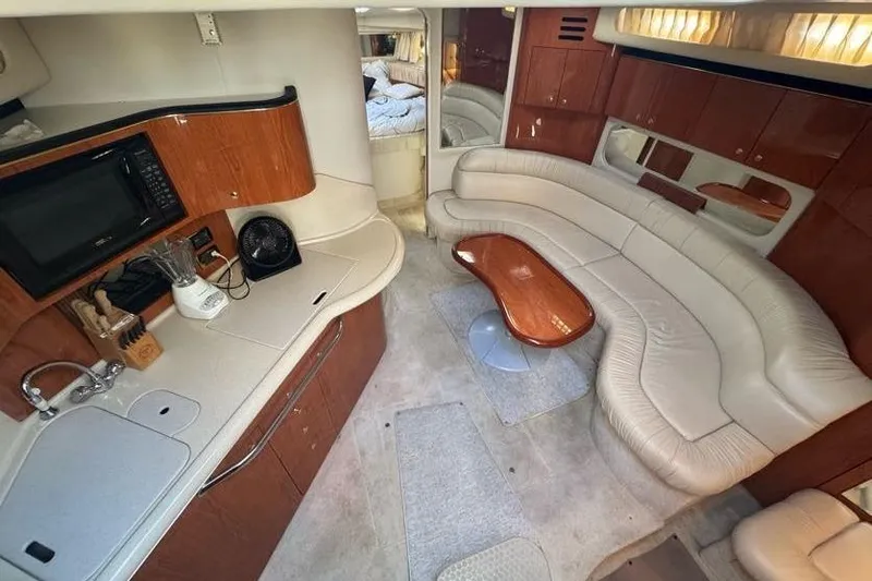 Slide: The Image of Luxurious interior of 2001 Sea Ray 380 Sundancer yacht with kitchen and seating area. - 27