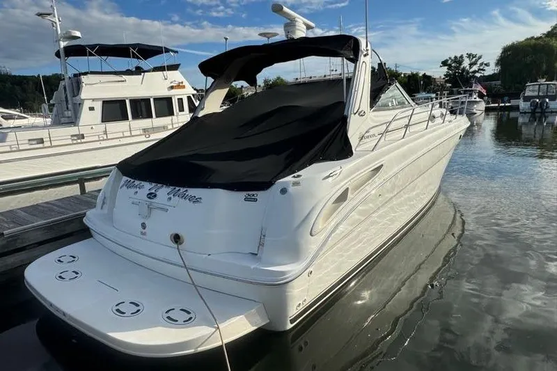 Slide: The Image of 2001 Sea Ray 380 Sundancer yacht docked at marina under clear sky. - 3