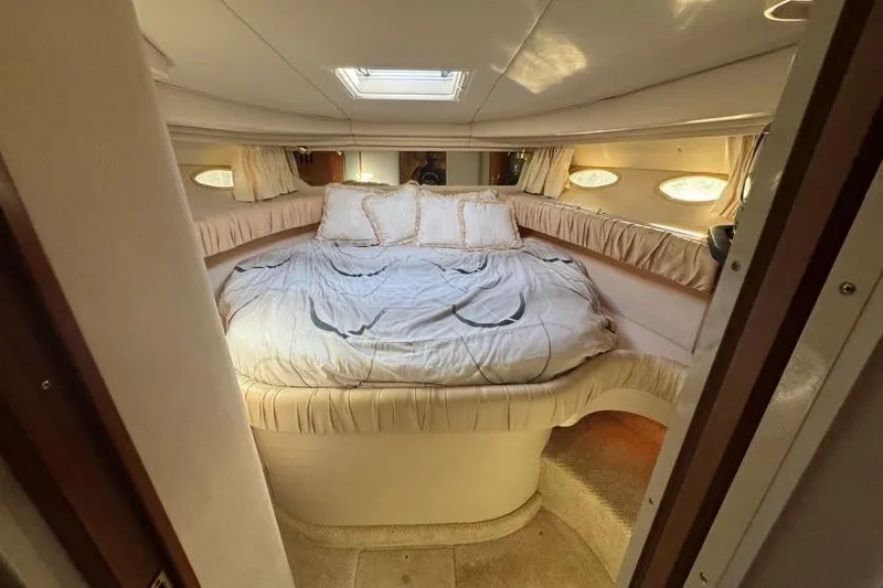 Slide: The Image of Luxurious cabin interior of 2001 Sea Ray 380 Sundancer with cozy bed and skylight. - 31