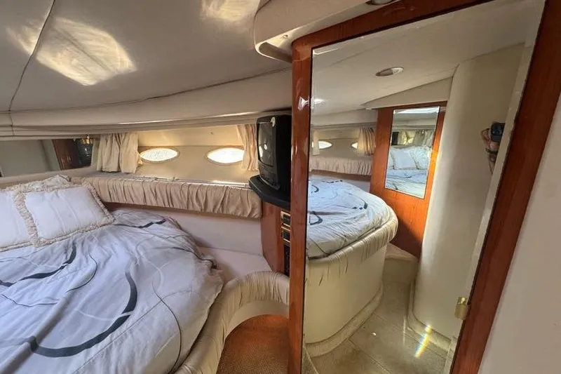 Slide: The Image of Interior of 2001 Sea Ray 380 Sundancer yacht with cozy bedroom and mirror. - 33