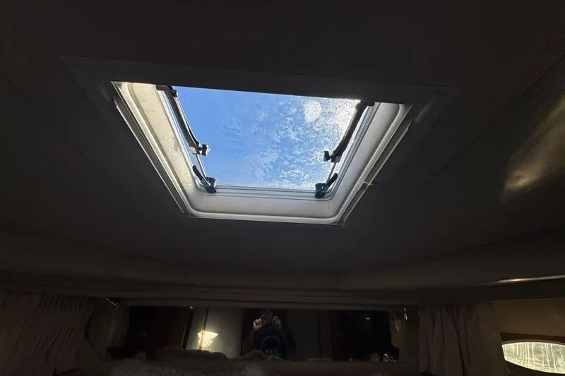 Slide: The Image of Skylight view from 2001 Sea Ray 380 Sundancer cabin, showing clear blue sky. - 34