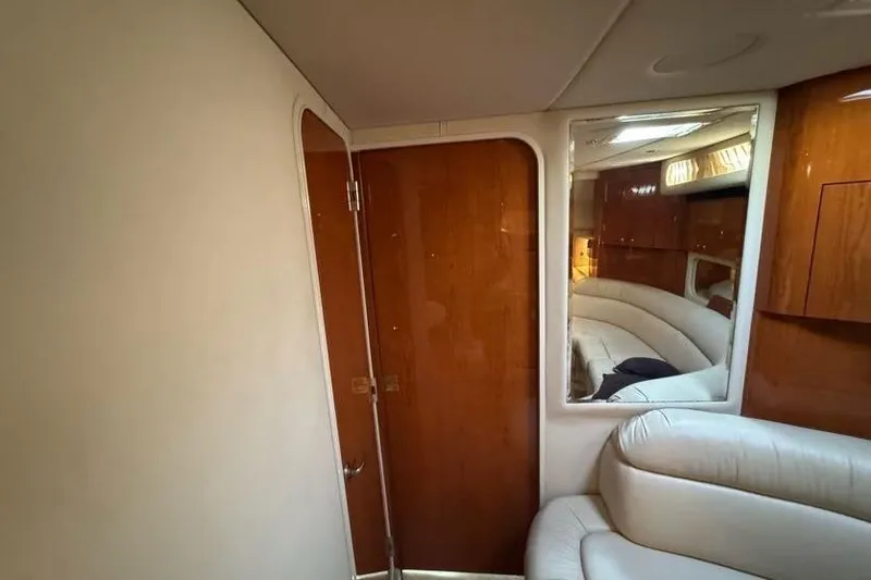 Slide: The Image of Interior of 2001 Sea Ray 380 Sundancer with wood paneling and leather seating. - 36