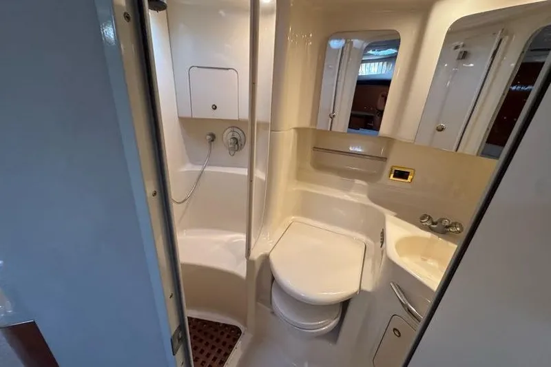 Slide: The Image of 2001 Sea Ray 380 Sundancer bathroom with shower, toilet, and sink. - 38