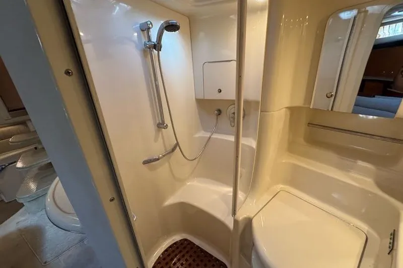 Slide: The Image of Bathroom interior of 2001 Sea Ray 380 Sundancer yacht, featuring shower and seating area. - 39