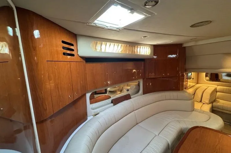 Slide: The Image of Luxurious interior of 2001 Sea Ray 380 Sundancer with plush seating and wooden cabinetry. - 42
