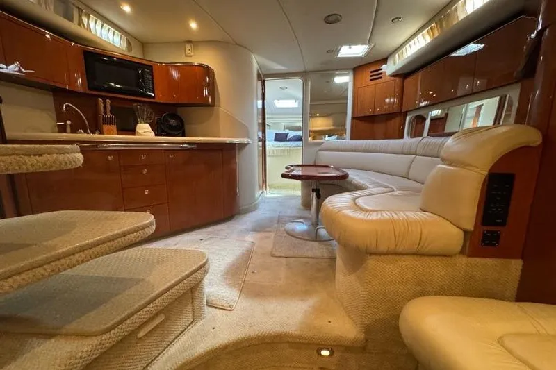 Slide: The Image of Luxurious interior of a 2001 Sea Ray 380 Sundancer yacht with plush seating and kitchenette. - 43