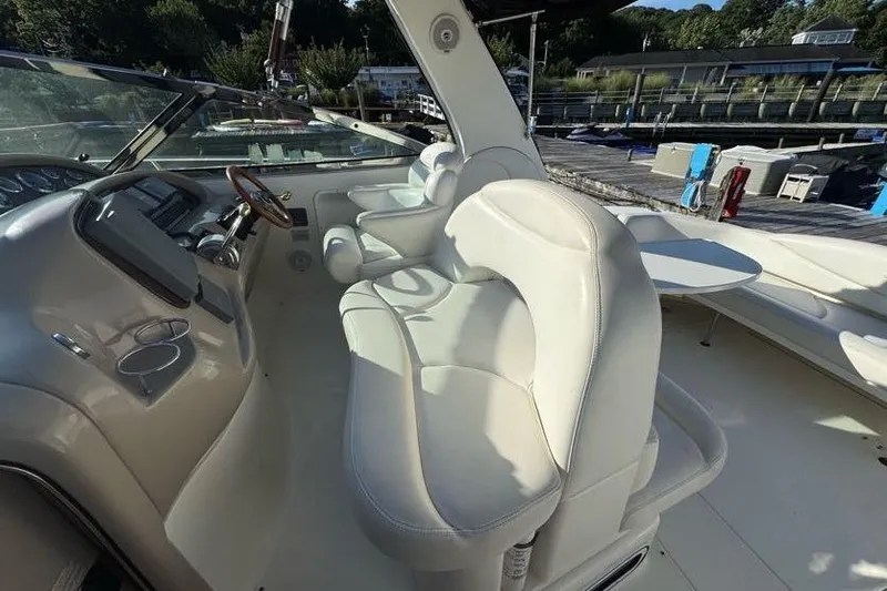 Slide: The Image of 2001 Sea Ray 380 Sundancer cockpit with white leather seating and control panel. - 45